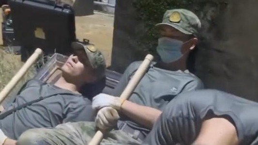 奋战一夜后，子弟兵抱着铁锹睡着了